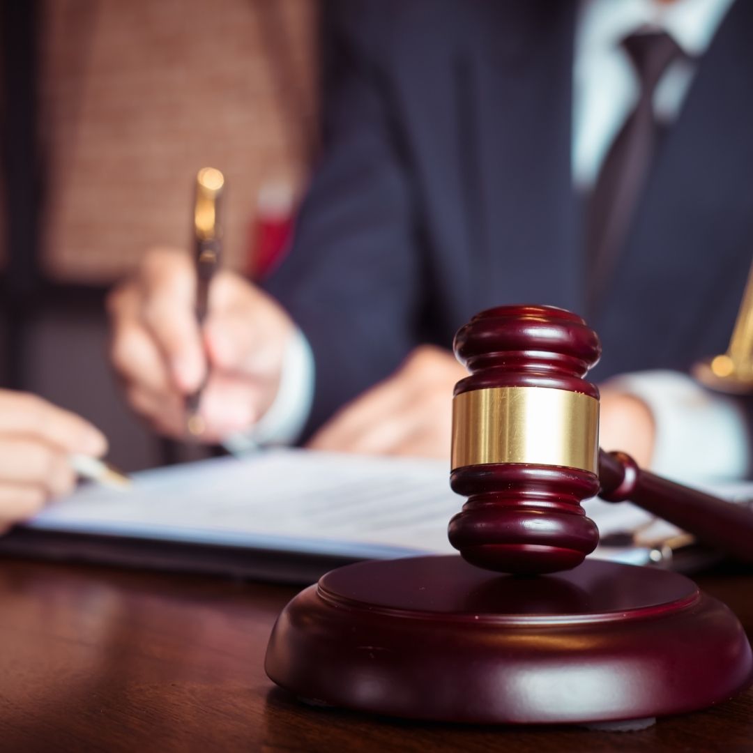 gavel, blurred attorney writing in background