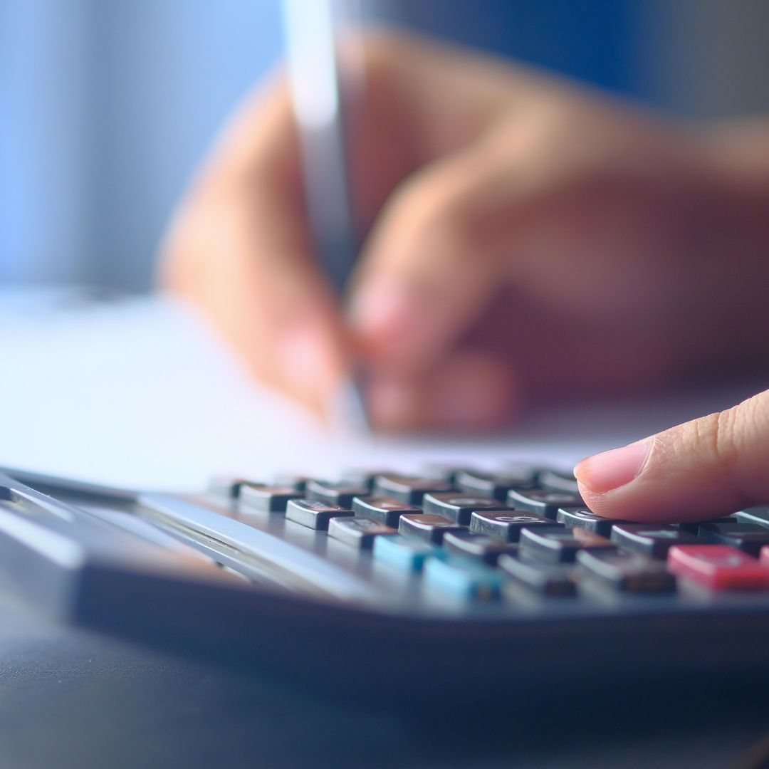 close-up of finger using calculator