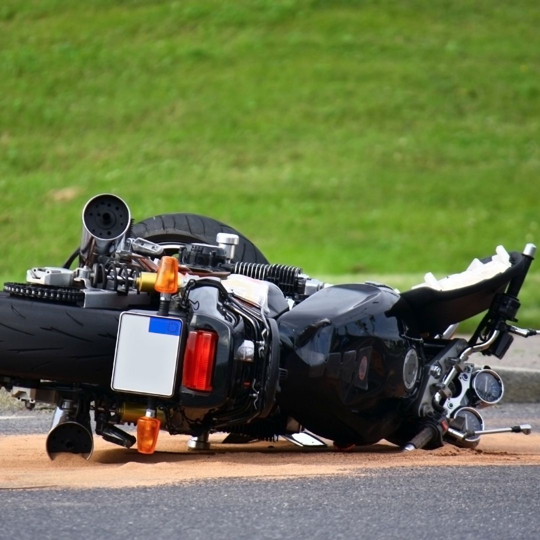 motorcycle lying on side of road